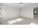 Bright bedroom boasts neutral walls, plush carpet, closet space, and natural light at 1236 Cricket St, Elon, NC 27244
