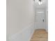 Bright hallway with wood-look floors, paneled walls, and a contemporary front door at 1236 Cricket St, Elon, NC 27244