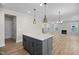Kitchen boasts a gray island with a white countertop, stainless appliances, and an open floorplan at 1236 Cricket St, Elon, NC 27244