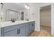 Bathroom featuring double vanity with gray cabinets and black fixtures at 1302 Cricket St, Elon, NC 27244