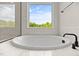 Bathroom with stand alone tub with black fixtures and a walk-in shower at 1302 Cricket St, Elon, NC 27244