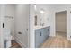 Bathroom featuring double vanity with blue cabinets and wood-look flooring at 1302 Cricket St, Elon, NC 27244