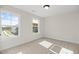 Bright bedroom with neutral carpet, modern trim, and a view of the neighborhood at 1302 Cricket St, Elon, NC 27244