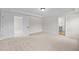 Large bedroom features neutral carpet, trim, and adjacent bathroom at 1302 Cricket St, Elon, NC 27244