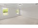 Light, airy bedroom with neutral carpet and paint features large windows at 1302 Cricket St, Elon, NC 27244
