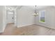 Dining area with elegant light fixture and ample natural light at 1302 Cricket St, Elon, NC 27244