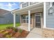Inviting front porch with brick accents and decorative columns welcomes you home at 1302 Cricket St, Elon, NC 27244