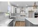 Bright kitchen with an island, stainless steel appliances, designer backsplash, and ample storage at 1302 Cricket St, Elon, NC 27244