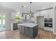 Modern kitchen with an island, stainless steel appliances, stylish pendants, and ample cabinet space at 1302 Cricket St, Elon, NC 27244