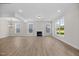 Spacious living room with a fireplace, lots of windows, and modern lighting at 1302 Cricket St, Elon, NC 27244