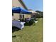 Spacious, level backyard is ready for an event with tables set up under various canopy tops at 1305 Chronicle Dr, Durham, NC 27703