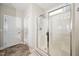 Bright bathroom featuring a walk-in shower with glass doors and neutral wall paint at 1305 Chronicle Dr, Durham, NC 27703