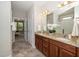 Spacious bathroom featuring double sinks, granite countertops, and a separate glass-enclosed shower at 1305 Chronicle Dr, Durham, NC 27703