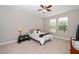 Cozy bedroom with a comfortable bed, two windows offering natural light, and a ceiling fan at 1305 Chronicle Dr, Durham, NC 27703