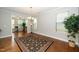 Bright dining room featuring hardwood floors, natural light, and a chandelier at 1305 Chronicle Dr, Durham, NC 27703