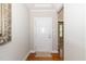 Bright entryway with gleaming hardwood floors and a white front door, leading into the home at 1305 Chronicle Dr, Durham, NC 27703