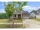 Charming home with a two-car garage, inviting front porch, and beautifully landscaped front yard at 1305 Chronicle Dr, Durham, NC 27703