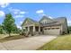 A well-maintained home with a two-car garage, appealing front porch, and a lush lawn at 1305 Chronicle Dr, Durham, NC 27703