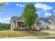 Beautiful home featuring a welcoming front porch and well-maintained landscaping, enhancing its curb appeal at 1305 Chronicle Dr, Durham, NC 27703