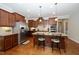 Spacious kitchen featuring stainless steel appliances, granite countertops, and dark wood cabinetry at 1305 Chronicle Dr, Durham, NC 27703