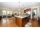 Open-concept kitchen and living area with a kitchen island and stainless steel appliances at 1305 Chronicle Dr, Durham, NC 27703
