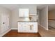 Wet bar area featuring modern white cabinetry, creating a sleek and functional space at 1305 Chronicle Dr, Durham, NC 27703