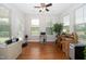 Well-lit home office with hardwood floors, desk, and outdoor access at 1305 Chronicle Dr, Durham, NC 27703