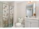 Bathroom featuring decorative butterfly shower curtain, tile floor, toilet and white sink at 132 Deardom Way, Chapel Hill, NC 27516