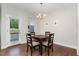 Dining room with a table and four chairs, a modern light fixture, and an outside view at 132 Deardom Way, Chapel Hill, NC 27516
