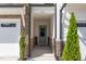 Inviting covered entryway with stone accents, leading to a modern front door of townhome at 132 Deardom Way, Chapel Hill, NC 27516
