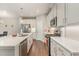 Modern kitchen featuring stainless steel appliances, quartz countertops, and hardwood floors at 132 Deardom Way, Chapel Hill, NC 27516