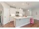 Kitchen with a kitchen island, stainless steel appliances, and white cabinets at 132 Deardom Way, Chapel Hill, NC 27516