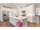 Bright kitchen showcasing a large island, stainless steel appliances, and white cabinetry at 132 Deardom Way, Chapel Hill, NC 27516