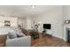 Bright living room with hardwood floors, fireplace, television, and sofa at 132 Deardom Way, Chapel Hill, NC 27516
