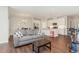 Open-concept living room with kitchen, hardwood floors, sofa, and modern lighting at 132 Deardom Way, Chapel Hill, NC 27516