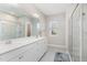 Bright bathroom with double sinks, a large mirror, a glass shower, and tiled floors at 132 Deardom Way, Chapel Hill, NC 27516