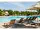 Community pool view featuring lounge chairs, trees and the water at 132 Deardom Way, Chapel Hill, NC 27516