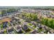 A well-designed neighborhood featuring manicured lawns and community areas with mature trees from above at 1320 Abington Dr, Mebane, NC 27302