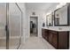 Modern bathroom with double sinks, a tiled shower, and a walk-in closet at 1320 Abington Dr, Mebane, NC 27302