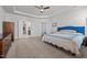 Bright bedroom featuring tray ceilings, a ceiling fan, and neutral-toned walls and carpet at 1320 Abington Dr, Mebane, NC 27302