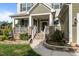 Charming front porch with stone accents, white railings, and a welcoming front door at 1320 Abington Dr, Mebane, NC 27302
