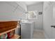 Bright laundry room with washer, dryer, and storage shelves at 1320 Abington Dr, Mebane, NC 27302