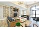 Stylish living room with stone fireplace, modern furnishings, and abundant natural light at 1320 Abington Dr, Mebane, NC 27302