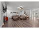 Comfortable living room space featuring a fireplace, staircase, and cozy leather furniture at 1320 Abington Dr, Mebane, NC 27302
