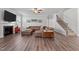 Cozy living room featuring a fireplace, staircase, and comfortable leather furniture at 1320 Abington Dr, Mebane, NC 27302