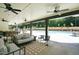 Covered outdoor patio with comfortable seating, ceiling fans, and views of the pool at 1320 Abington Dr, Mebane, NC 27302