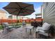 Outdoor patio with stamped concrete, furniture and a large umbrella for shade at 1320 Abington Dr, Mebane, NC 27302