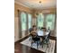 Bright dining room featuring a modern chandelier, large windows and a cozy rug at 1320 Double Oak Ln, Willow Springs, NC 27592