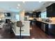 Open kitchen featuring dark cabinets, granite countertops, stainless steel appliances, and a breakfast bar at 1320 Double Oak Ln, Willow Springs, NC 27592