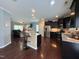 Spacious kitchen with dark cabinetry, stainless steel appliances, granite counters, and hardwood flooring at 1320 Double Oak Ln, Willow Springs, NC 27592